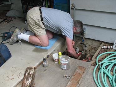 Sprinkler Repair San Diego technician clears cogged valves
